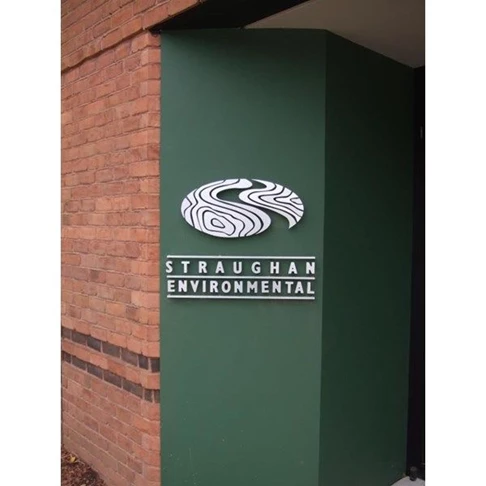 White Dimensional Letters & Logo on Green Backdrop