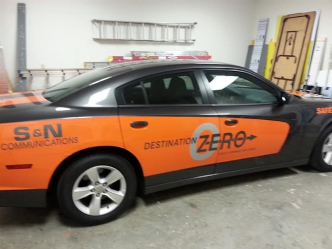Orange color change vinyl and cut vinyl graphics make this Charger a big hit with their employees.  I think that the orange makes the car go FASTER!