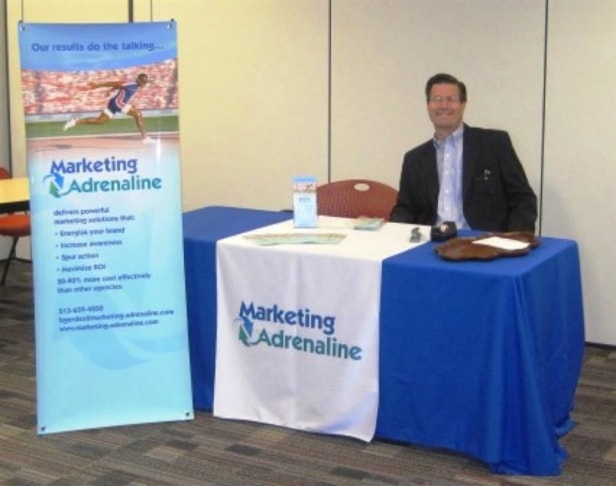 Trade show banner, table throw and brochures. (Trade Show Products by Signs Now Cincinnati for Brad Gerdes, Marketing Adrenaline, Cincinnati, OH)	