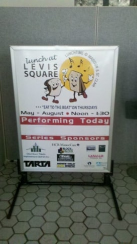 Sidewalk sign for Lunch at Levis Park in Downtown Toledo, Ohio.