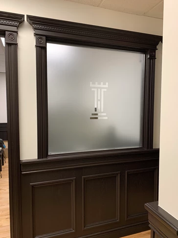 Frosted office window with the company logo cut out  