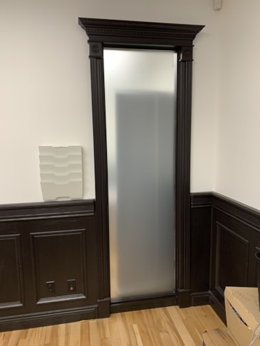 Window frost applied to shared window between two offices to create privacy.