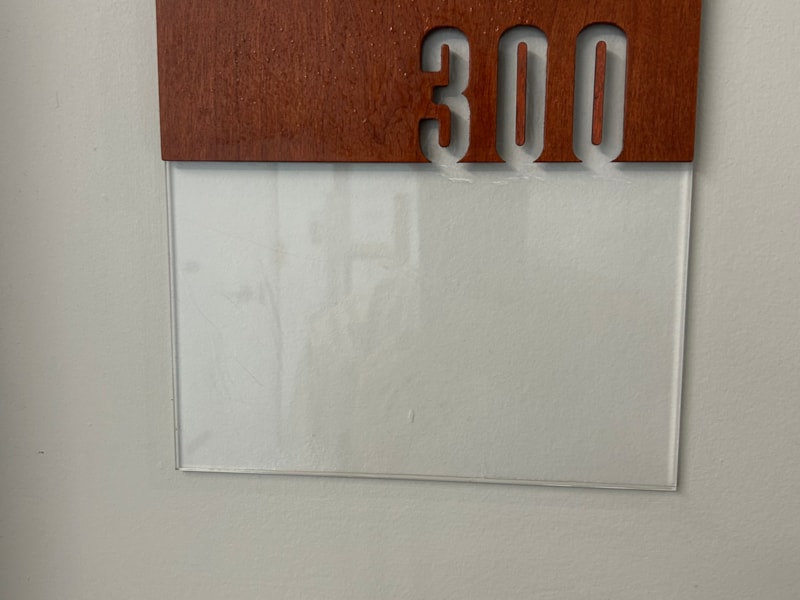 Directory and Wayfinding Signage | Property Management | Calgary, Alberta | Acrylic | wood and acrylic room number sign with the number 300, showing the removal of the previous wayfinding graphic.