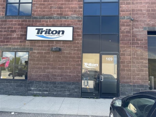 Bold and professional—Triton Transport Ltd. welcomes visitors with clean exterior signage and a clearly marked entrance at unit 169.