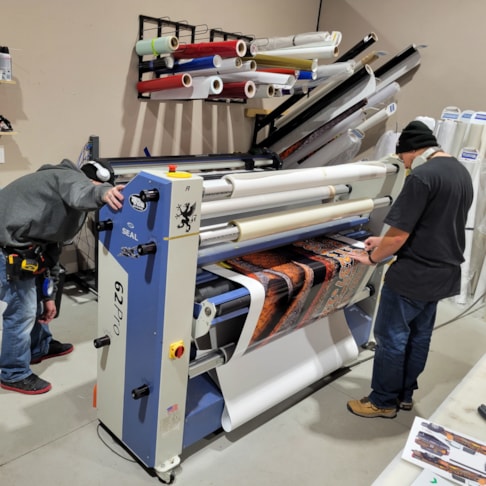 Laminating the vinyl for a truck wrap