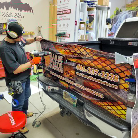 Installation of a tailgate wrap for Barse Pride Construction