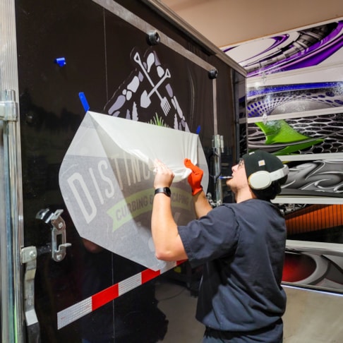 Installation of trailer graphics for Distinctive Edge Curbing and Landscaping