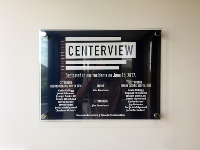 Interior Acrylic and Brushed Metal Sign with White Ink and Standoffs for City of Raymore in Raymore, Missouri