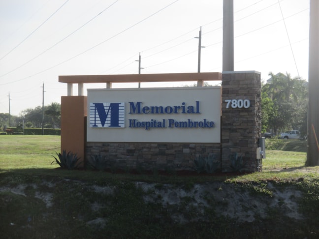 Custom fabricated, double-sided illuminated monument sign, with  Stone veneer decorative embellishments