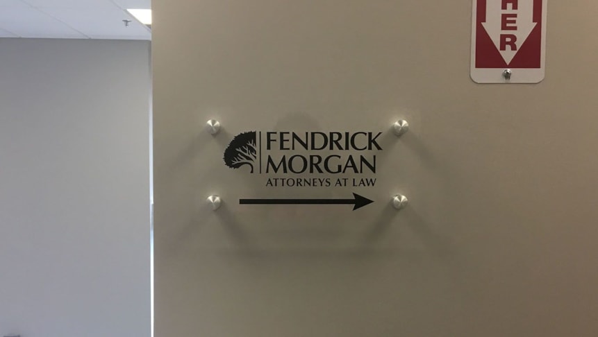 Vinyl placed on clear acrylic for this interior hallway directional signage for Fendrick Morgan.