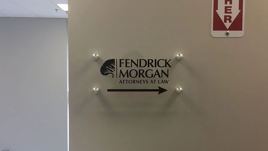 Vinyl placed on clear acrylic for this interior hallway directional signage for Fendrick Morgan.