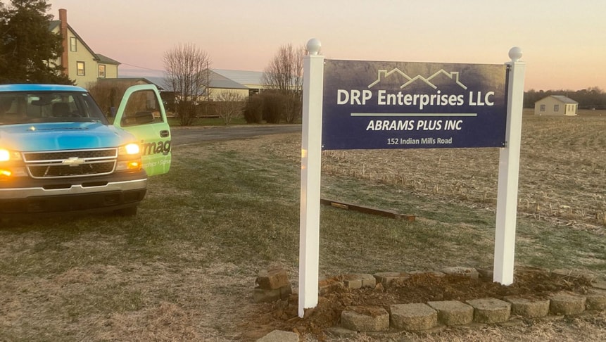 New post and panel sign for Deck Restoration, installed where their old sign stood.