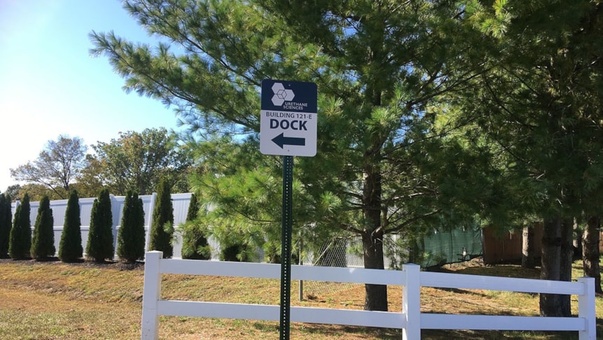 Directional parking lot signage showing supply trucks where to go for deliveries.