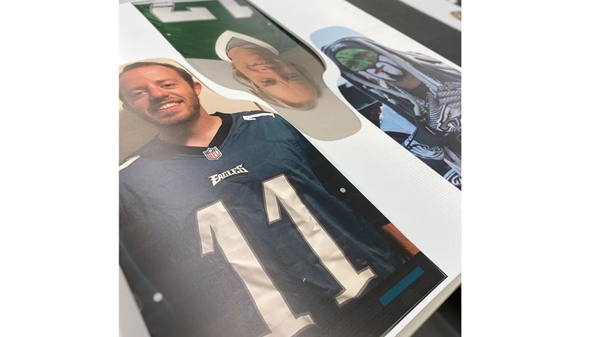 Eagles fans coroplast cutouts waiting to undergo the final step before being packaged for delivery to Lincoln Financial.