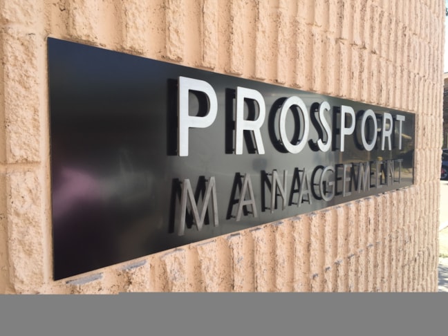 Flat cut out aluminum on black poly metal with 1/2 black stand-offs.