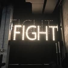 Open-faced metal sign with incandescent bulbs