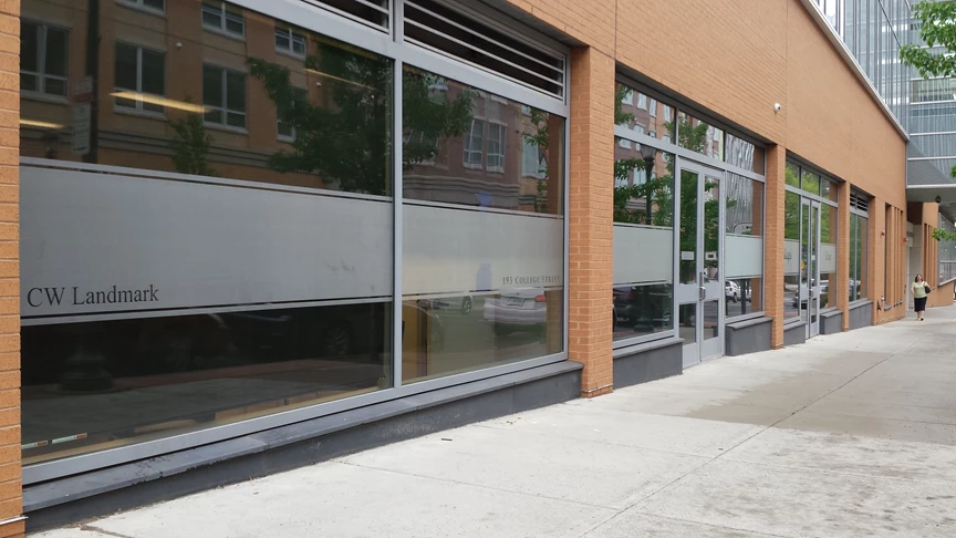 Digital and frosted vinyl used to brand the street side glass walls