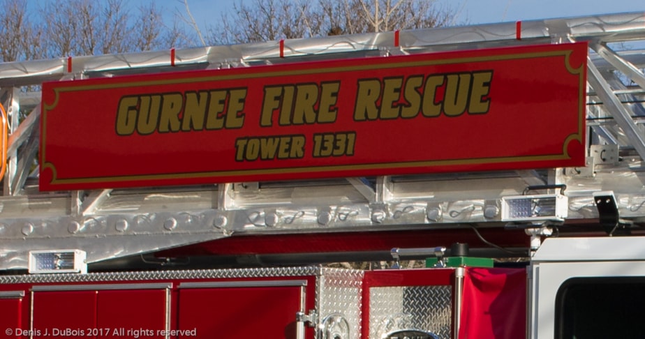 Close up shot of gold and black graphics on tower of fire truck
