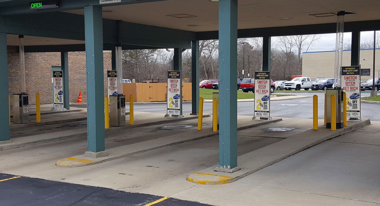 Banner stands mounted to piers for advertising promotions at drive through windows Gurnee, IL