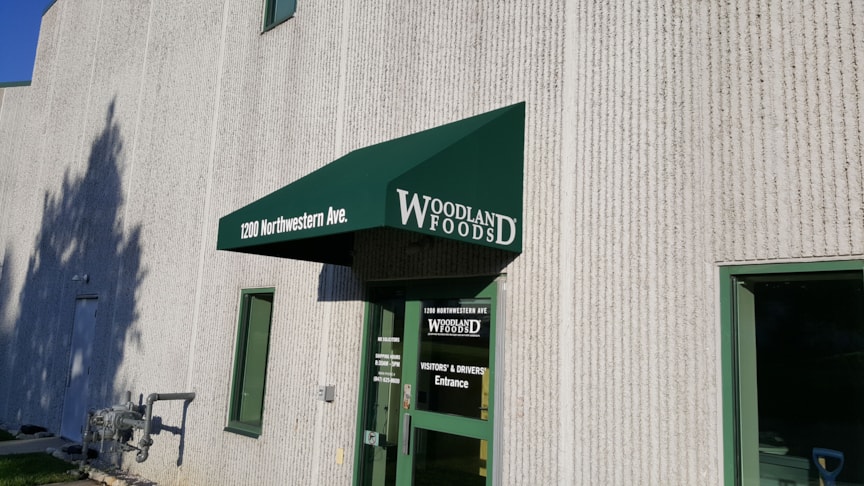 Fabric awning above doorway at Woodland Foods manufacturing facility in Gurnee, IL
