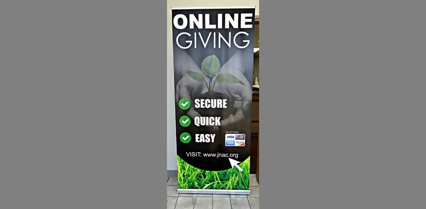 Giving campaign graphic designed, printed and installed in retractable banner stand by Signs Now / Image 360 Gurnee for Jesus Name Apostolic Church in Waukegan IL