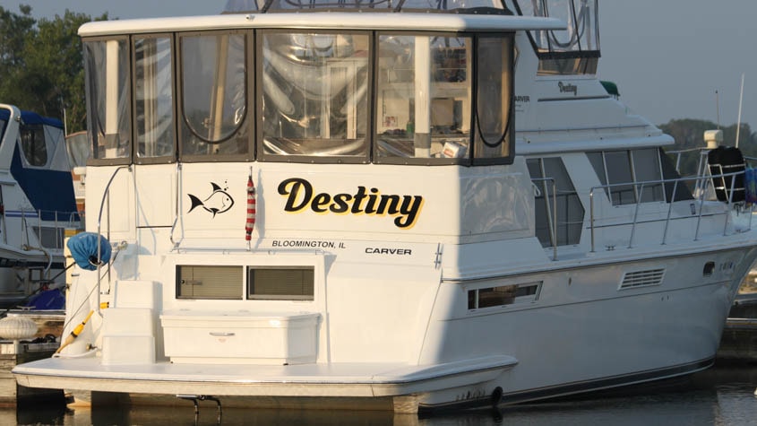 40 Carver done in water at North Point Marina, Winthrop Harbor IL.  We designed and applied the fish graphic and name in black and metallic gold. The name is repeated on both sides below the flybridge .