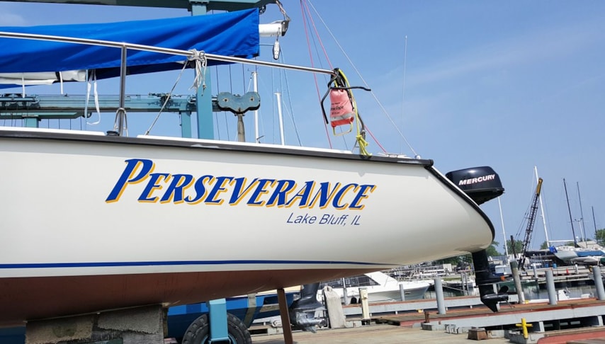 Lettering on port side of sailboat in Vivid Blue with Yellow drop shadow