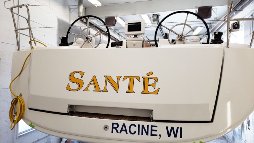 Boat Name Lettering with Hailing Port in Navy Blue and Yellow.  Cool font choice.  