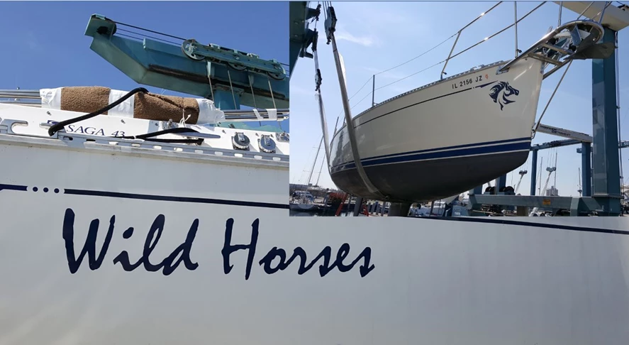 Name and horse graphic applied to sides near stern and at bow of sailboat