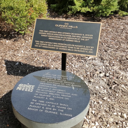 Bronze plaque on post for time capsule at Gurnee Mills mall