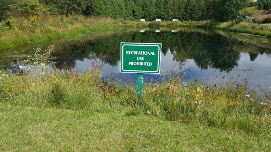 Post and panel sign by pond for Home Owners Association (HOA) in Lake Forest IL