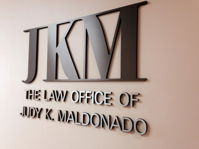 Bronze and Gun Metal Gray dimensional lettering and logo on wall of law practice in Gurnee IL