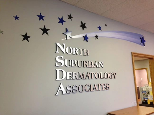 Metallic and painted dimensional lettering with vinyl graphics on doctors office reception wall in Gurnee IL