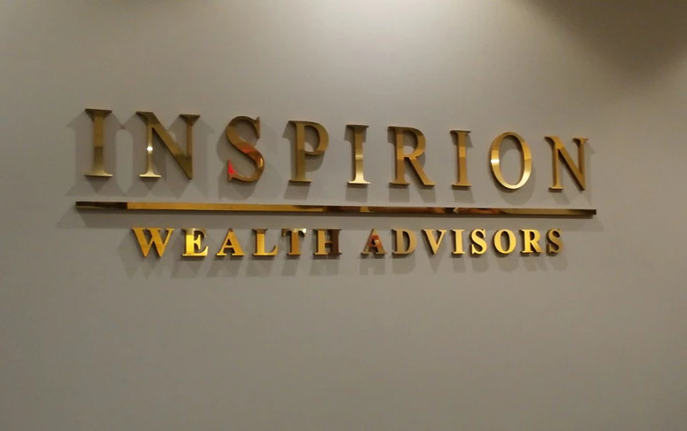 Gold dimensional letters behind reception desk in lobby Libertyville IL