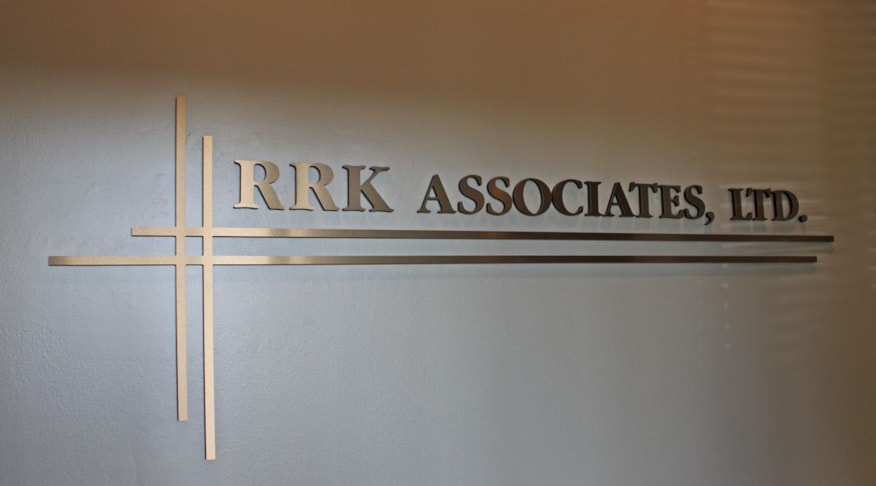 Metallic faced dimensional wall lettering at business entrance