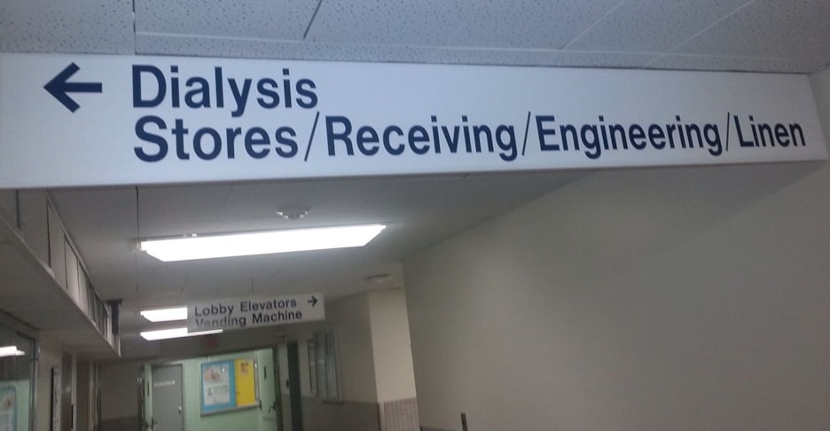 Ceiling mounted directional wayfinding sign in hospital