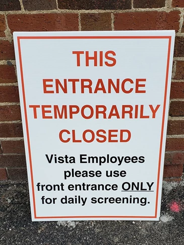 Sign to direct hospital employees to use one entrance only 