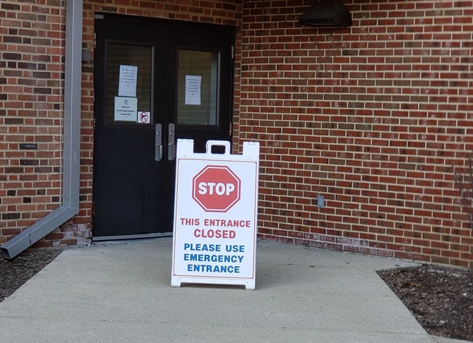 A-Frame sidewalk stop sign to block closed entrance at hospital for COVID-19