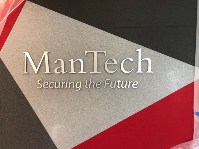 Some elegant, brushed silver, dimensional lettering for ManTech. Their logo and tagline installed on wall.