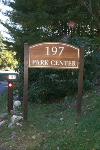 Carved post and panel signage